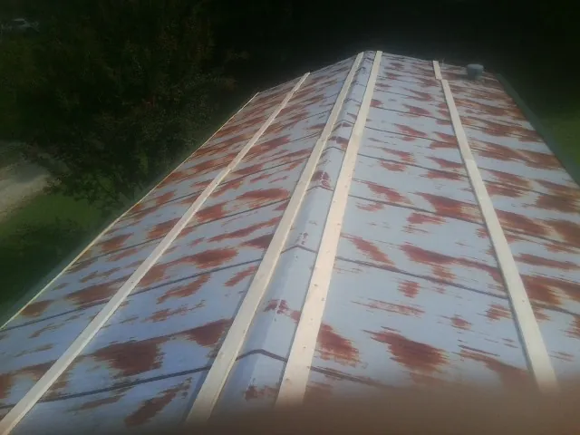 Rusted metal roof panels with new wood purlins before replacement — Storm Damage Roof Repair in Elberton by Roofing Brothers