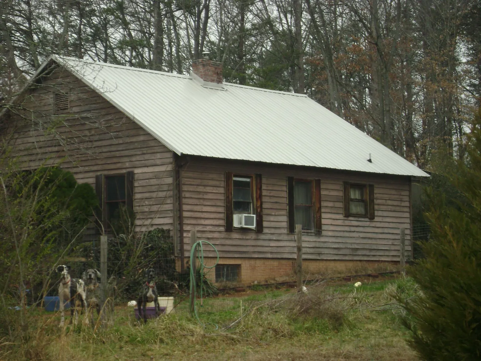 White metal roof on an old wood sided farmhouse, from a Metal Roof Installation job in Elberton